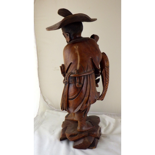 292 - An Oriental large hardwood carved figure of a fisherman 70cm tall