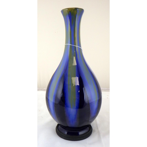 309 - A high fired pottery vase with metal base mount, in the manor of Burmantofts. Stamped 35cm tall