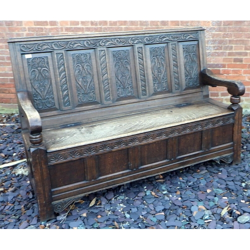 500 - A five panel carved oak settle with box seat, 168cm wide, ex The Retreat (64)