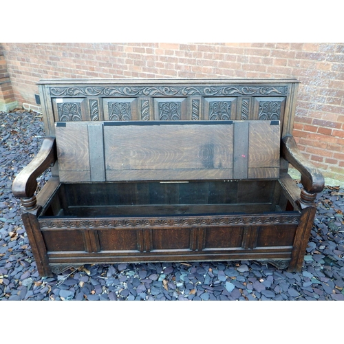 500 - A five panel carved oak settle with box seat, 168cm wide, ex The Retreat (64)