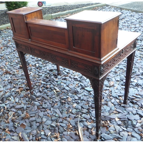 517 - An Edwardian mahogany, blind fretwork decorated writing table with leather inset top and side slides... 