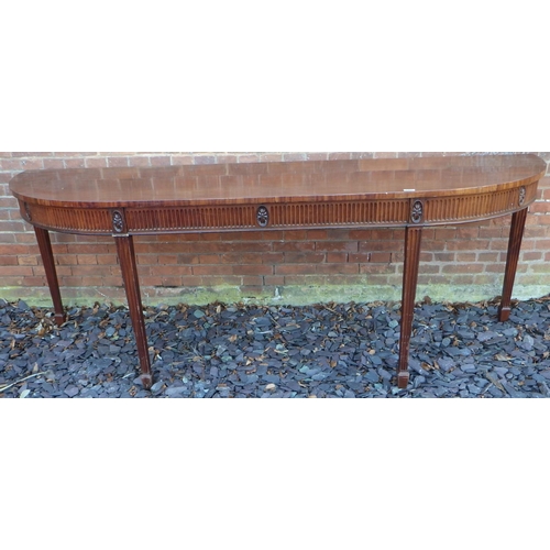 549 - A large mahogany serving table with curved ends on fluted square tapering legs with spade feet, 247c... 