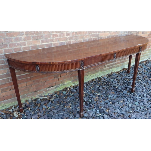 549 - A large mahogany serving table with curved ends on fluted square tapering legs with spade feet, 247c... 