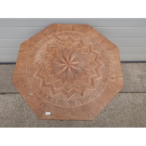 620 - A Continental inlaid low octagonal table, leg repaired, 65cm across