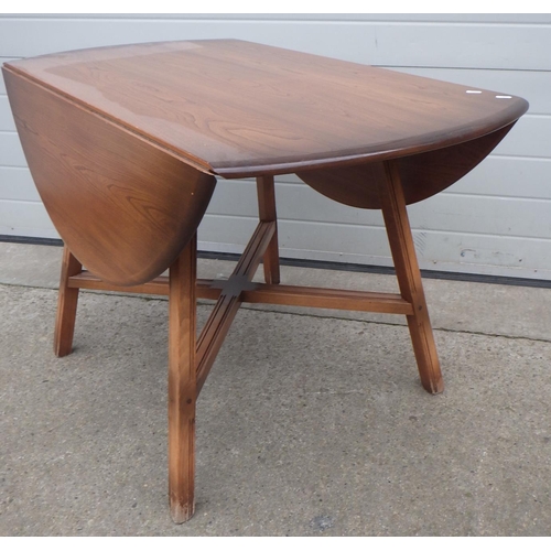 632 - An Ercol drop leaf dining table, 114cm across