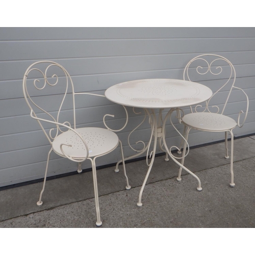 643 - A cream painted metal cafe table and pair of chairs