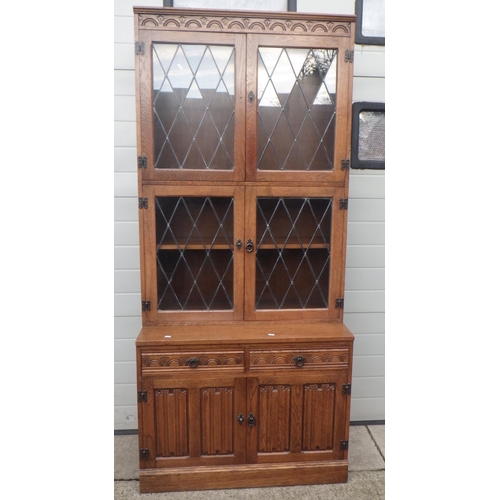 657 - An oak side cabinet with leaded glass doors, missing 3 handles, 92cm wide