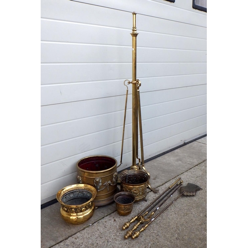 686 - A telescopic brass lamp standard, 3 fire irons, brass planters