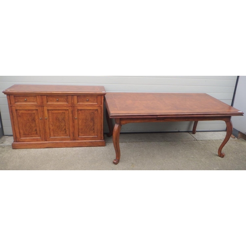 695 - A reproduction draw leaf dining table, 185cm long closed, 100cm wide, together with a matching sideb... 