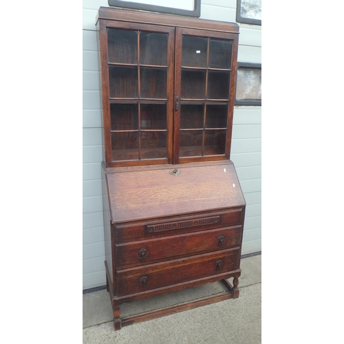 709 - A 1930's oak bureau bookcase, 92cm wide