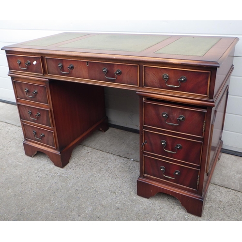 710 - A reproduction pedestal desk with leather inset top, 123cm wide