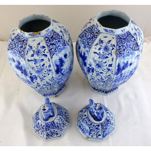 337 - A pair of 19thC octagonal blue and white ribbed Delft lidded urns signed J . V 38 CM tall, AF some c... 