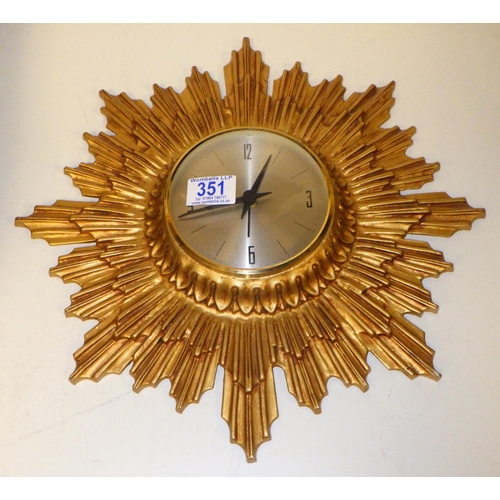 351 - A cast metal sunburst wall clock with modern battery movement 38cm diameter