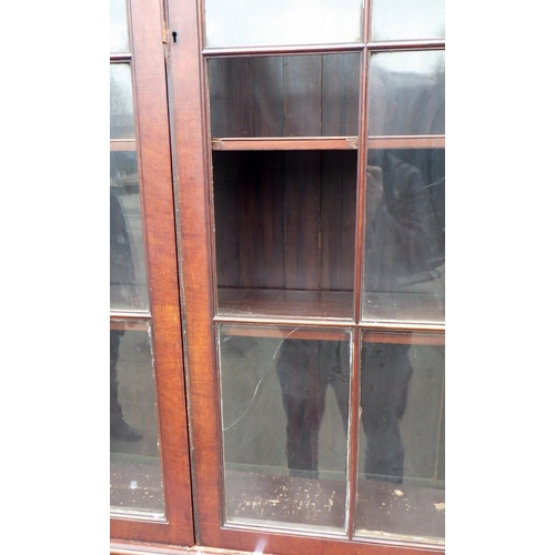 650 - An Edwardian mahogany bookcase, 112cm wide, 256cm tall, glass damaged