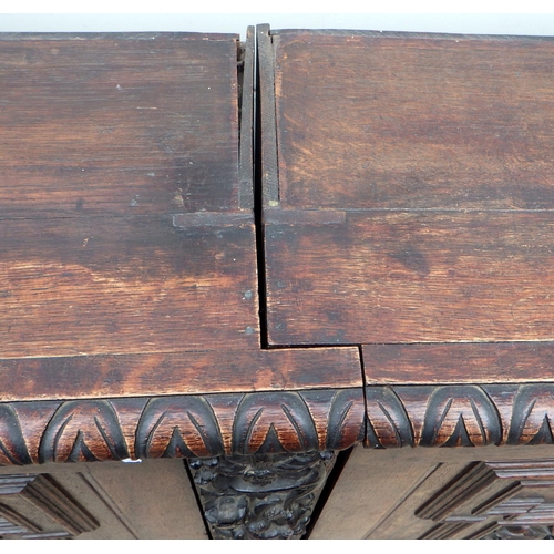 652 - A carved oak cupboard, in two sections, formerly part of a larger item, 174cm wide (a/f)