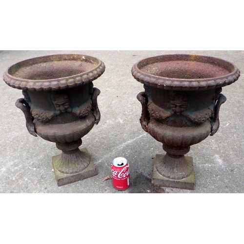 779 - A pair of small reproduction cast iron garden urns, 44cm tall