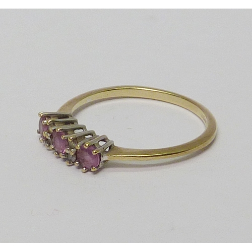 14 - A trilogy ring, 9ct gold set with three pink sapphires spaced with four small diamonds.  Approximate... 