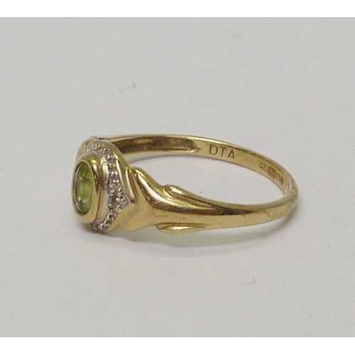 19 - A 9ct gold oval cut peridot halo ring with diamond accents.  Approximately 2gr gross / size P.  8138... 