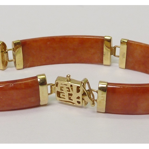 2 - A panel bracelet, yellow metal marked 14k / 585 and brown jade. 180mm long  
736811