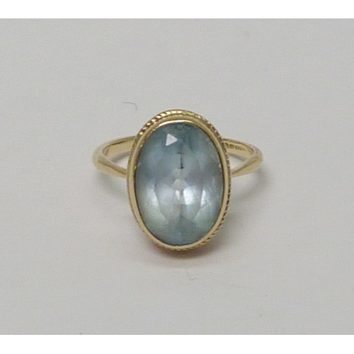 21 - A 9ct gold oval cut topaz cocktail ring.  Approximately 4gr gross  / size O.   813906