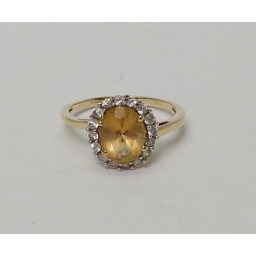 24 - A 9ct gold citrine & clear gemstone halo ring. 
 Approximately 2.5gr gross / size P 1/2. 
735517