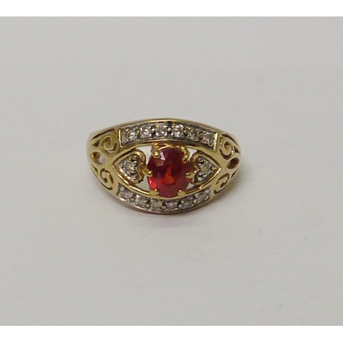 25 - A 9ct gold diamond & ruby dress ring with heart & openwork detail. Approximately 3.8gr gross / size ... 