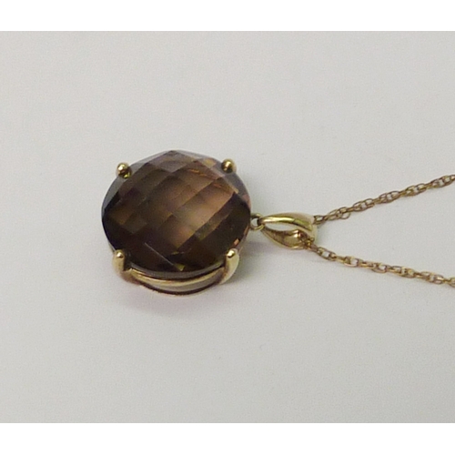 28 - A 9ct gold smoky quartz pendant suspended from a 9ct gold neck chain. Approximately 8.5gr gross/ 28m... 