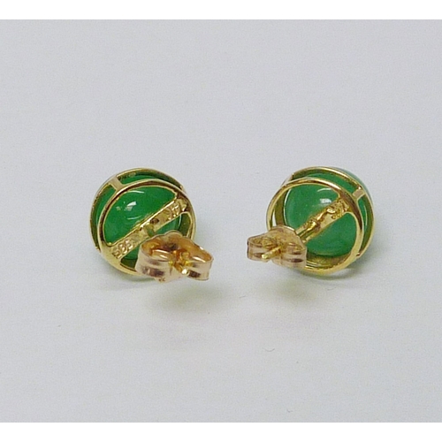 30 - A pair of stud earrings, yellow metal marked 14k 
 / 585 set with jade balls. stud earrings.  Approx... 