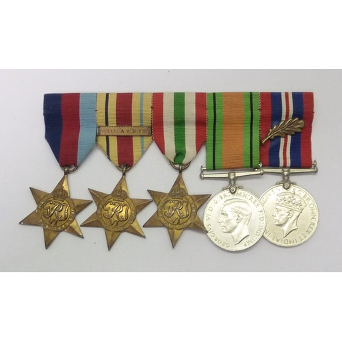 52 - A WW2 group of five medals comprising 1939-45 Star, Africa Star, Italy Star, Defence Medal, and War ... 