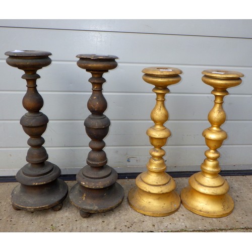 760 - Two pairs of painted turned wooden candle sticks, tallest 57cm tall (ex York Minster Stores)