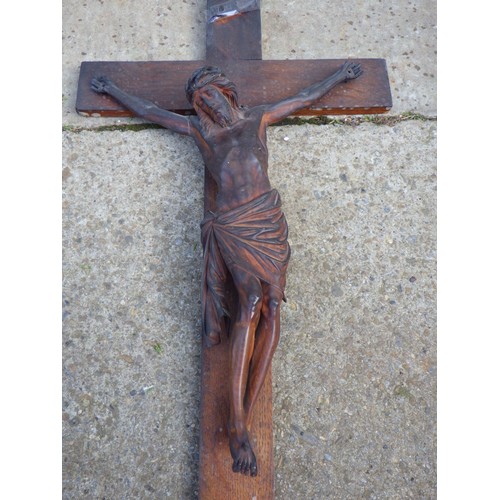 776 - A wooden crucifix with carved figure of Jesus, 76cm tall (ex York Minster Stores)