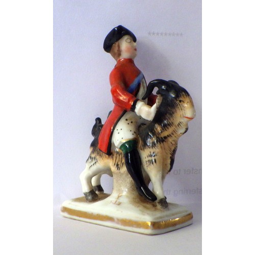 407 - A 19th C small porcelain soldier riding a ram / goat 7cm tall