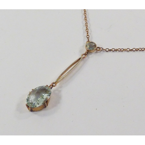 31 - A pendant necklace comprising a brilliant cut and an oval cut aquamarine stones in a yellow metal se... 