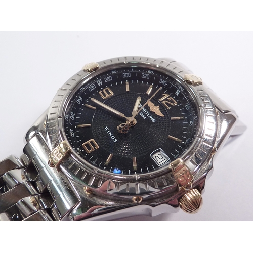 4 - A Breitling Wings bracelet watch having an automatic movement in a steel case with blue dial and uni... 