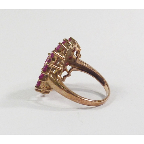 42 - A cluster ring comprising pink tourmaline stones in a 9ct gold setting incorporating a pierced friez... 