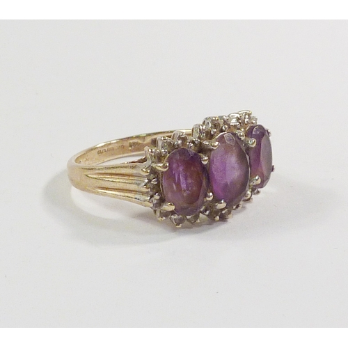 43 - A triple cluster ring comprising three pink amethysts surrounded by a line of diamonds in a 9ct gold... 