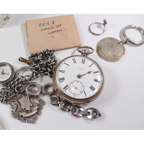 47 - A silver pocket watch having a key wind fusee movement in an open silver case, the whole suspended o... 