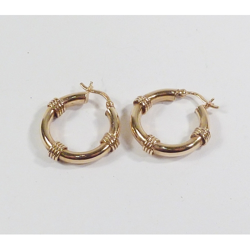 48 - A pair of hollow hoop earrings having twist ring embellishment, 9ct gold.  22mm diameter / approx 2.... 