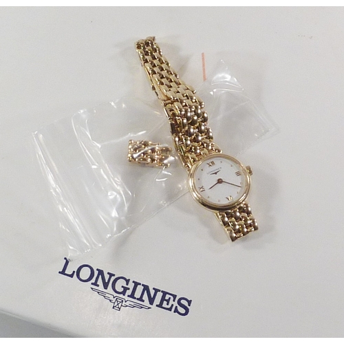 6 - A Longines ladies' bracelet watch having a  quartz movement under a white dial in an 18ct gold case ... 