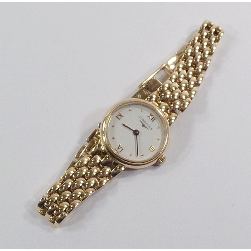 6 - A Longines ladies' bracelet watch having a  quartz movement under a white dial in an 18ct gold case ... 