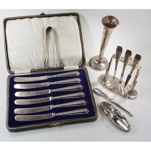 61 - A cased set of six silver handled butter knives; an Art Deco design silver part manicure set on stan... 