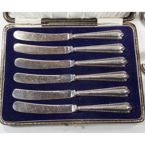 61 - A cased set of six silver handled butter knives; an Art Deco design silver part manicure set on stan... 