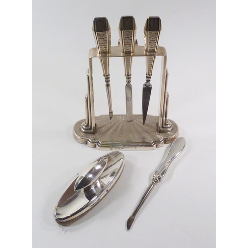 61 - A cased set of six silver handled butter knives; an Art Deco design silver part manicure set on stan... 