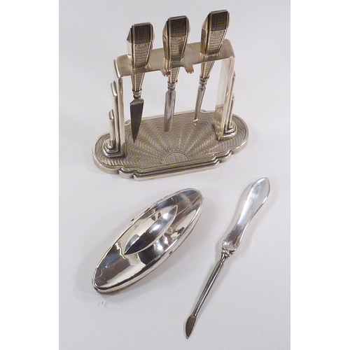 61 - A cased set of six silver handled butter knives; an Art Deco design silver part manicure set on stan... 