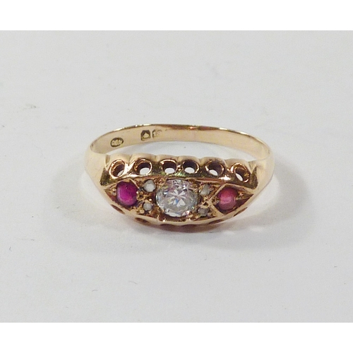 96 - A boat head ring, 18ct gold set with a central paste stone and two red stones the arrangement spaced... 