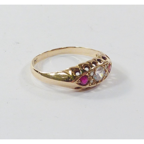 96 - A boat head ring, 18ct gold set with a central paste stone and two red stones the arrangement spaced... 