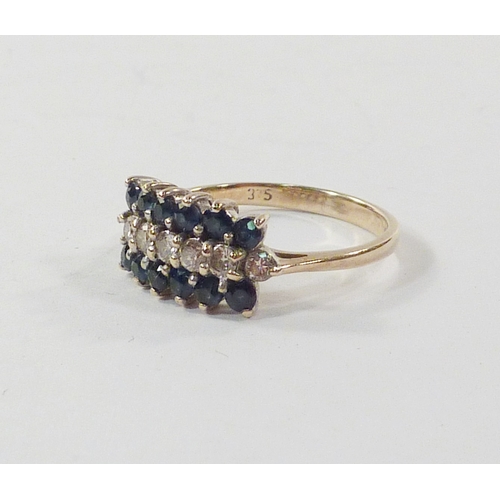 99 - A triple row cluster ring comprising diamonds and sapphires in a 9ct gold setting.  A/F one diamond ... 