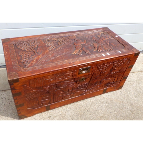 894 - A brass bound carved camphorwood chest