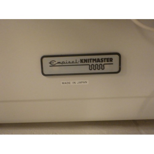 895 - An Empisal knitting machine and accessories