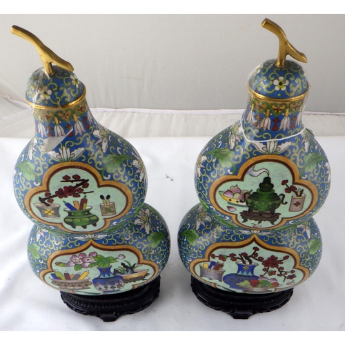 111 - A pair of Chinese cloisonné  double gourd shaped flasks with carved stands.  Each 33cm tall on stand... 